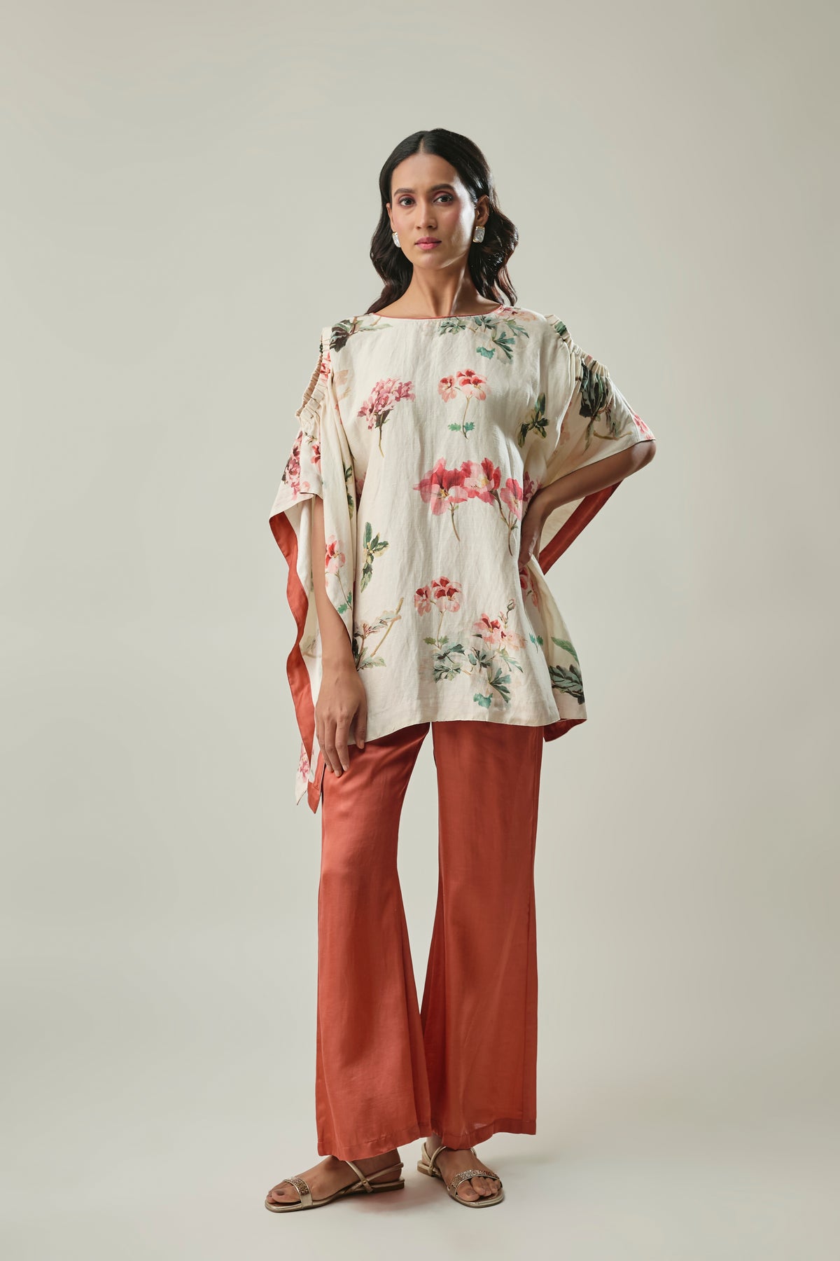 Model wearing ivory & rust satin linen co-ord set
