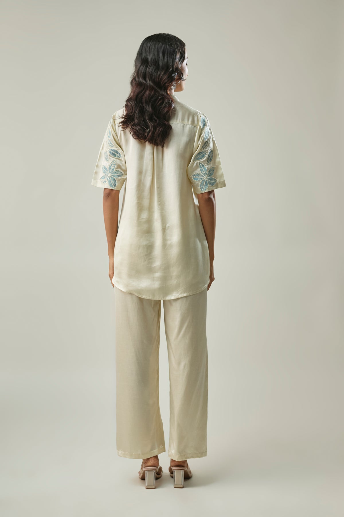 Model wearing ivory satin linen co-ord set