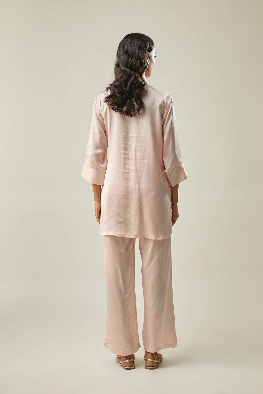 Model wearing peach satin linen co-ord set