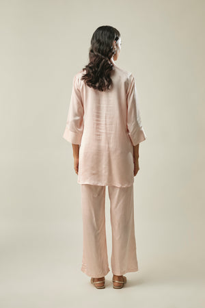 Model wearing peach satin linen co-ord set