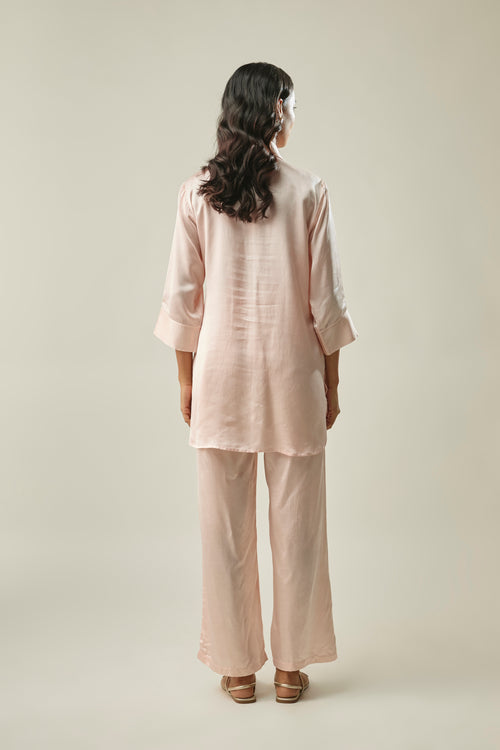 Model wearing peach satin linen co-ord set