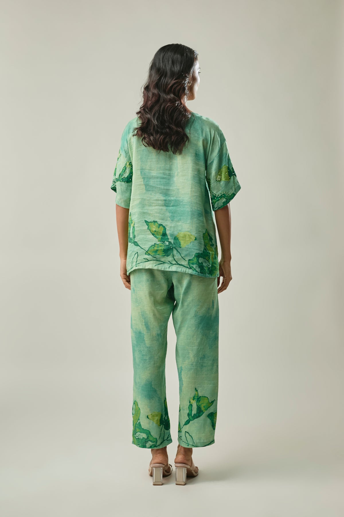 Model wearing green satin linen co-ord set